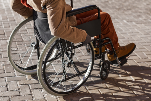 man seated in a self-propelled wheelchair